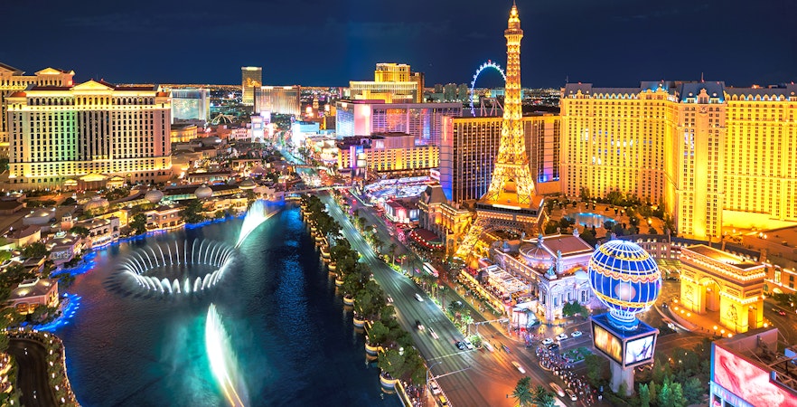 Aerial view of Las Vegas Strip illuminated at night, showcasing iconic casinos and hotels.
