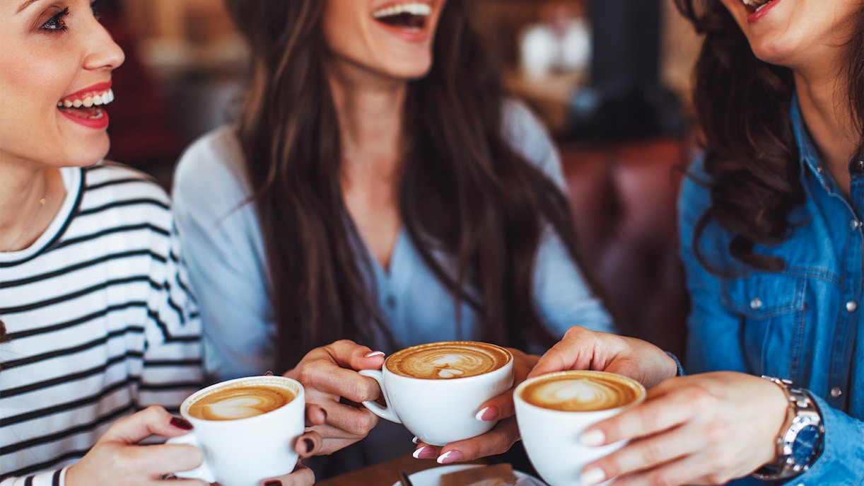 Friends enjoying coffee at NEMO Museum Amsterdam restaurant.