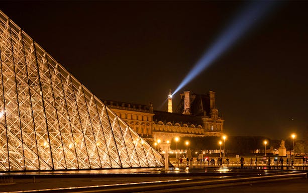 Louvre Pyramid and Eiffel Tower illuminated at night, Paris.