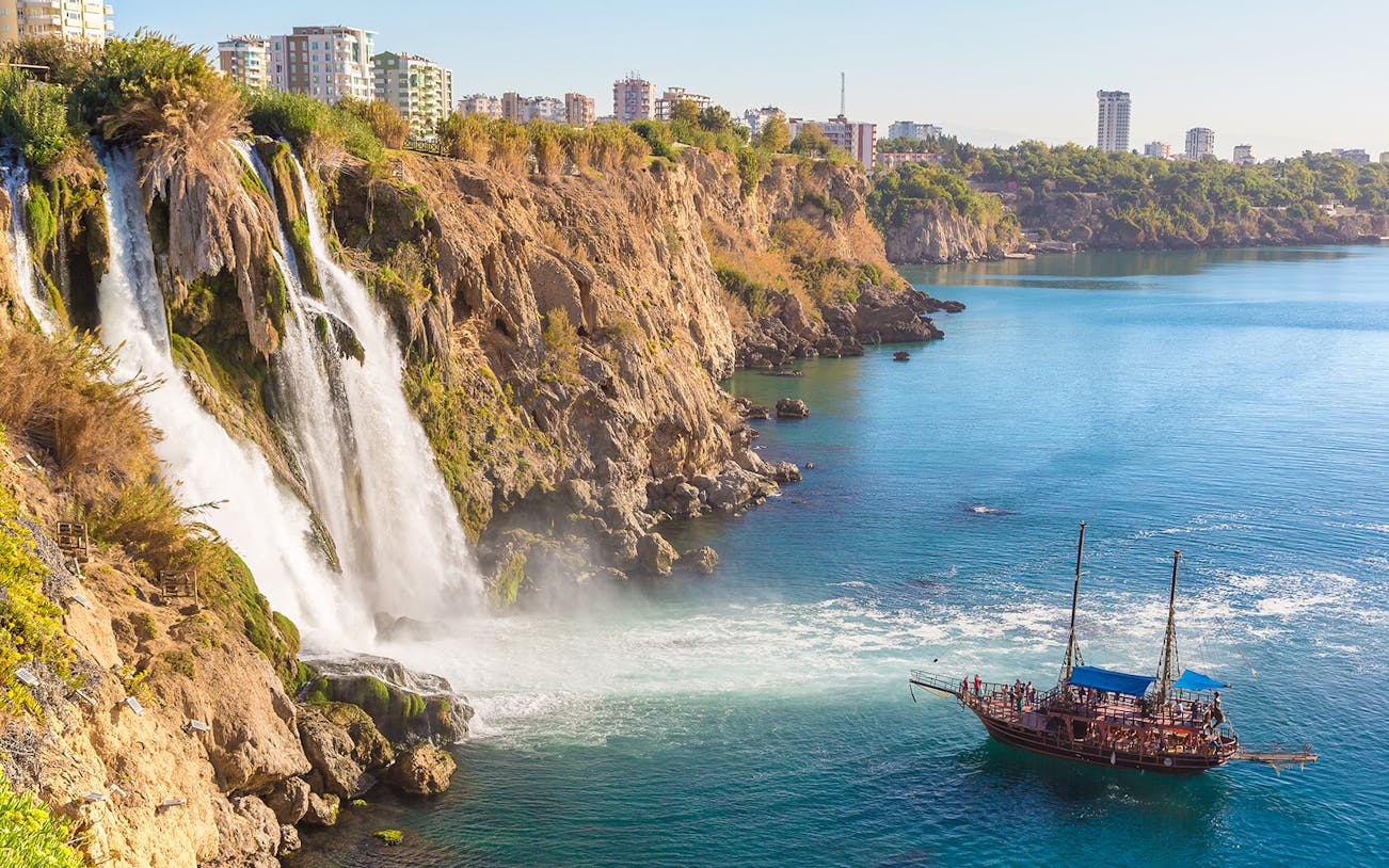 Boat approaching Lower Duden Waterfall on a guided tour in Antalya, Turkey.