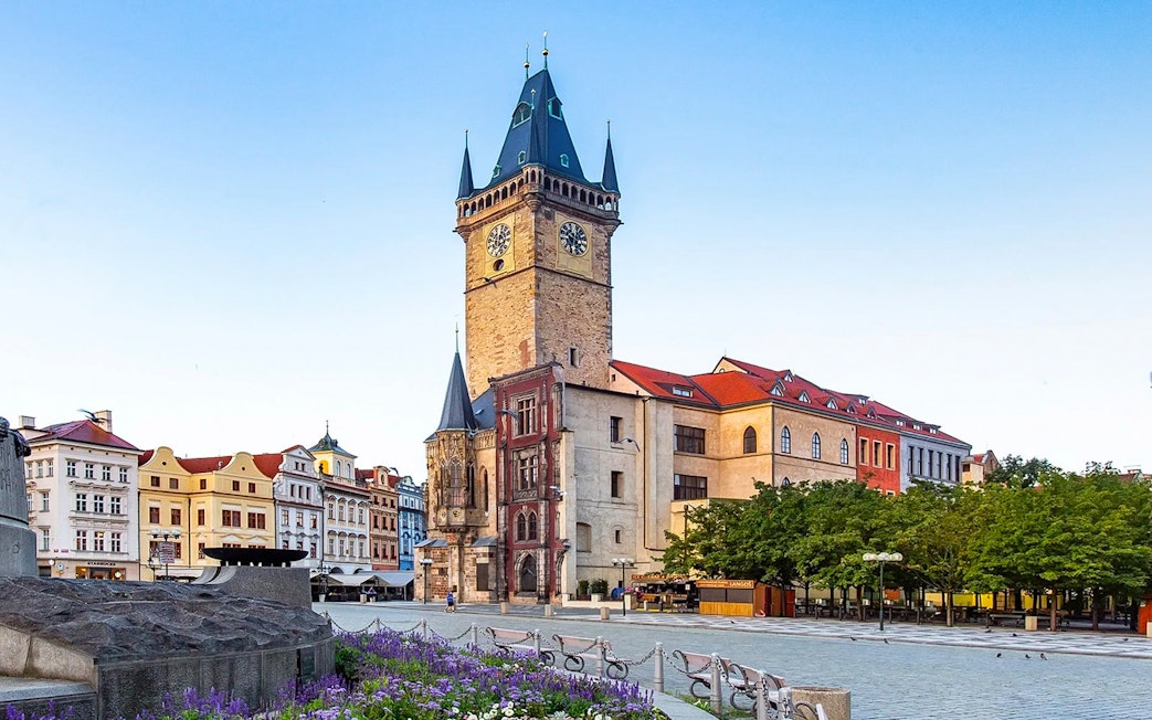 Old Town Hall tower in Prague with surrounding historic buildings.