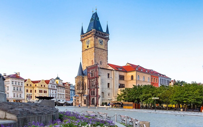 Old Town Hall tower in Prague with surrounding historic buildings.