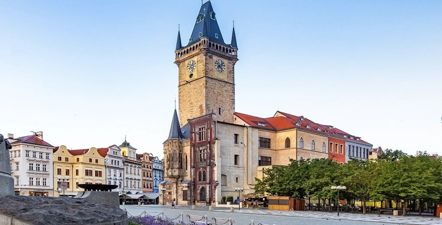 Old Town Hall tower in Prague with surrounding historic buildings.