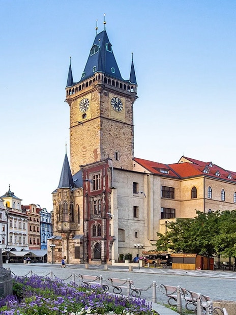 Old Town Hall tower in Prague with surrounding historic buildings.