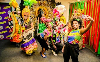 Participants in colorful costumes during a behind-the-scenes tour of the Rio Carnival.