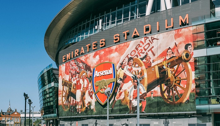 Emirates Stadium exterior with fans gathering, London.