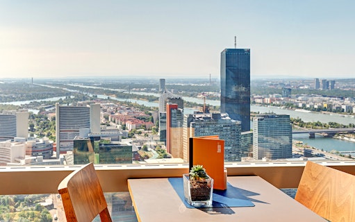View from Donauturm Wien overlooking Vienna skyline and Danube River.