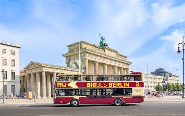 Hop-on hop-off bus in front of Brandenburg Gate, Berlin.