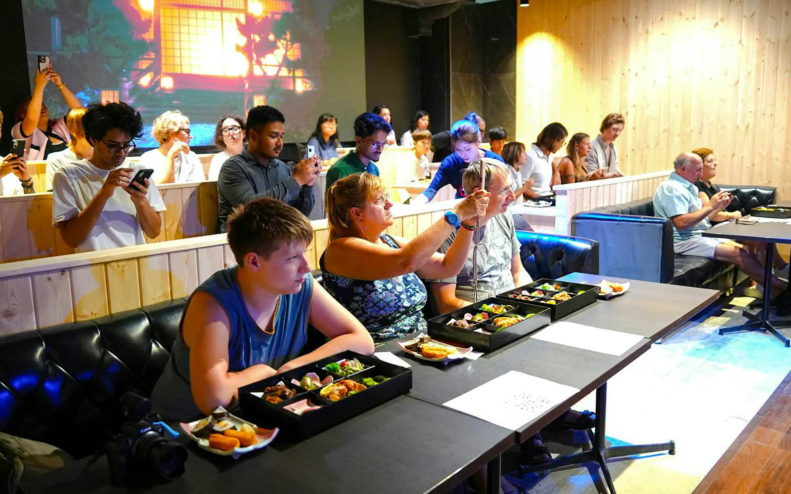Guests enjoying a Chanko meal during an authentic sumo experience in Japan.