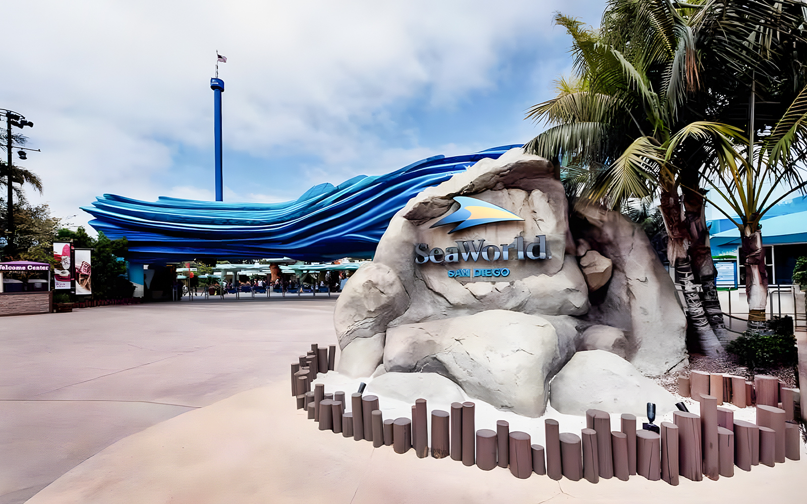 SeaWorld San Diego entrance with wave sculpture and palm trees.