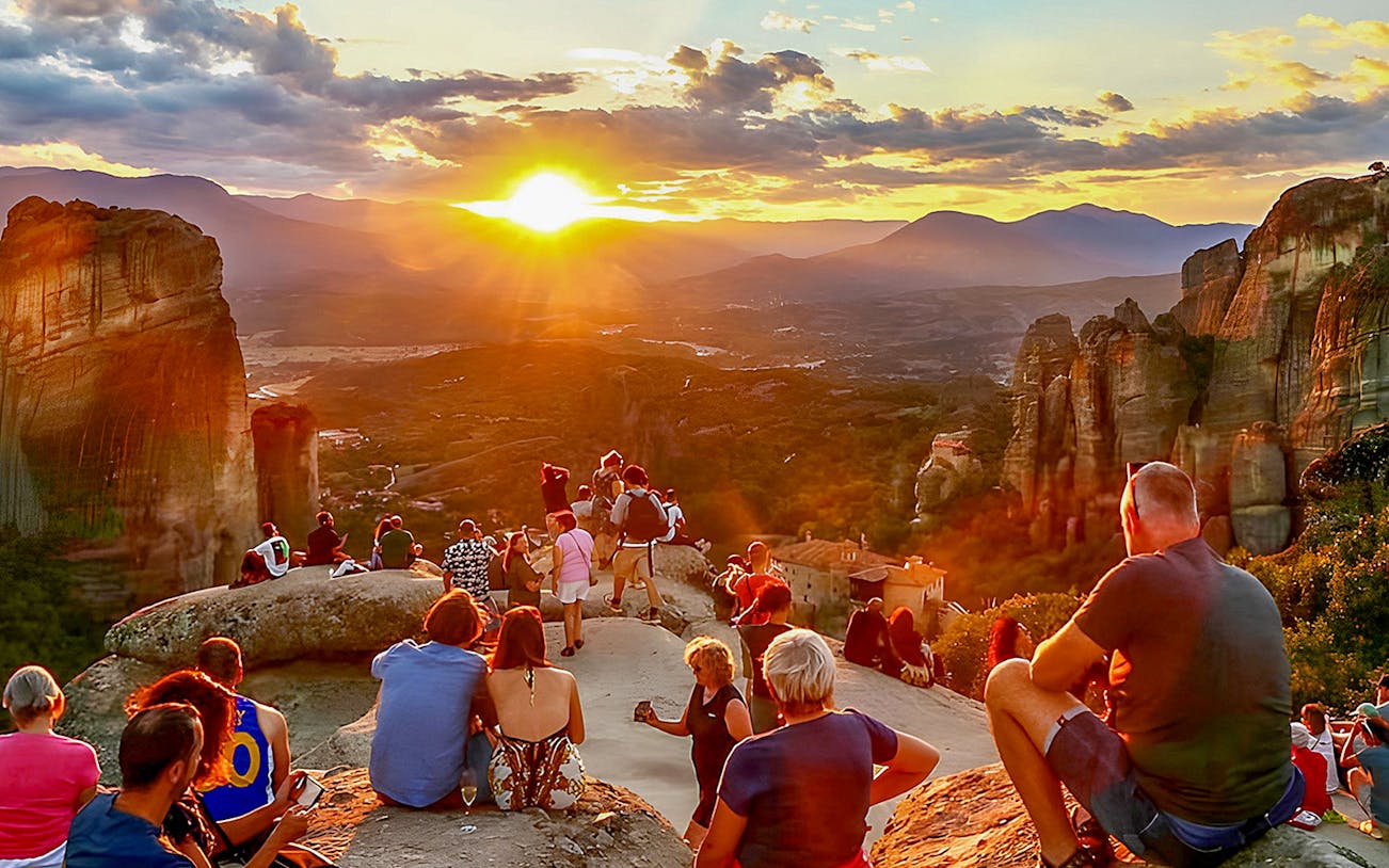 Guests viewing Meteora Monasteries at sunset in Greece.