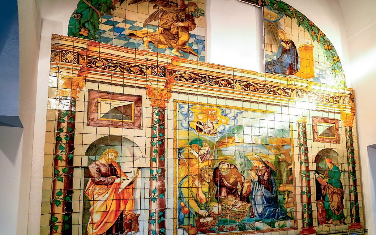 National Tile Museum mural depicting religious scenes in Lisbon, Portugal.