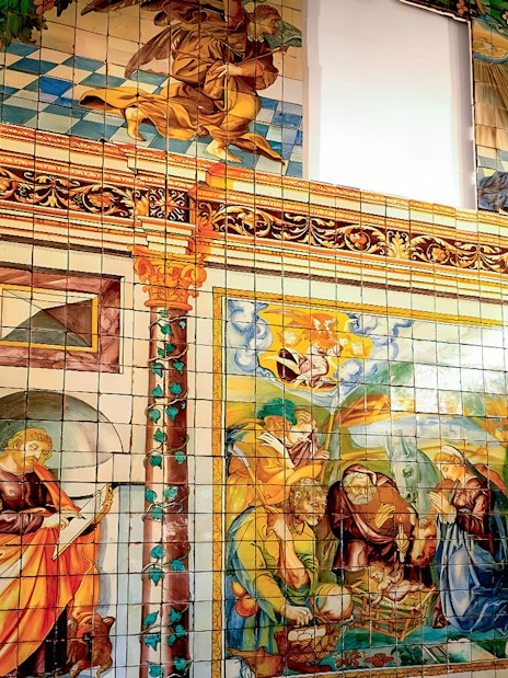 National Tile Museum mural depicting religious scenes in Lisbon, Portugal.