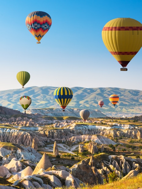 Hot air balloons over Cappadocia's unique rock formations and valleys.