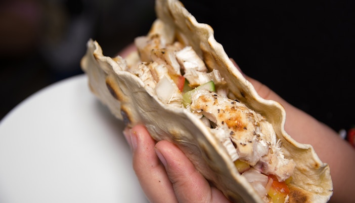 Traditional Mexican taco with cheese, served on a wooden board in Mexico City.