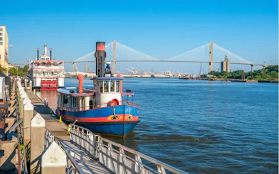 Riverboat docked along Savannah River with Talmadge Memorial Bridge in the background, Savannah.