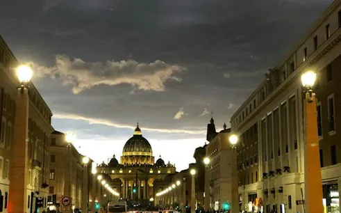 St. Peter's Basilica illuminated at dusk during Rome night bike tour.