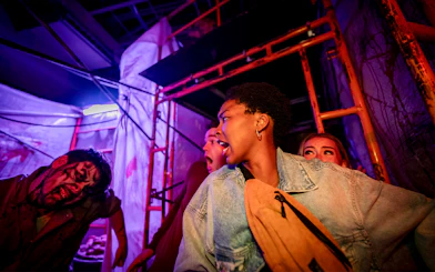 Visitors react in fear inside the SCarowinds Maze at Six Flags Snicker's Halloween Event.
