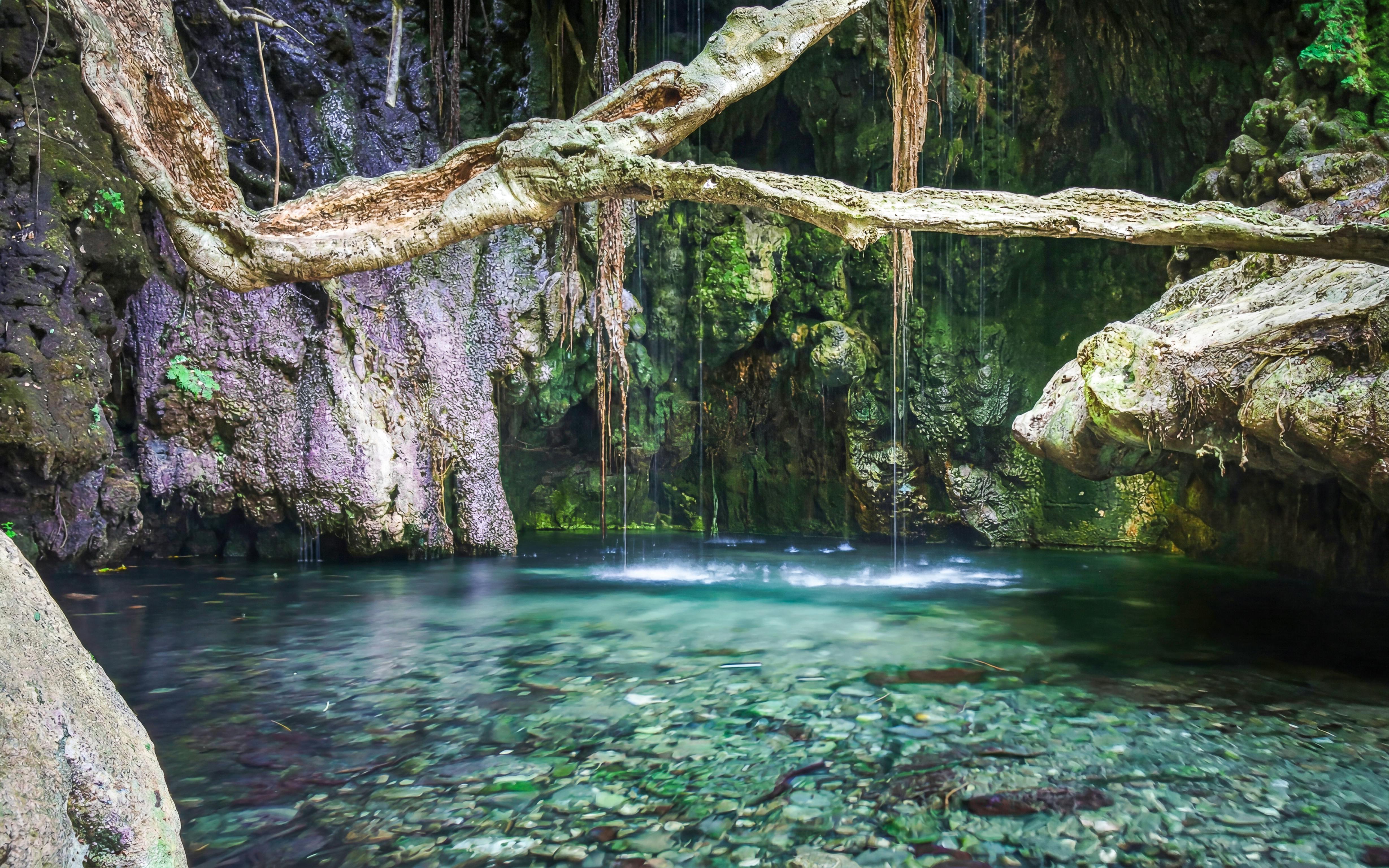 Aphrodite's Baths with clear water and surrounding rock formations in Paphos, Cyprus.
