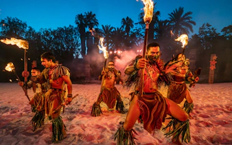 Traditional Polynesian fire-knife dancers performing at PortAventura.