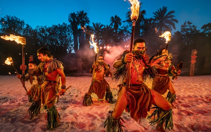 Traditional Polynesian fire-knife dancers performing at PortAventura.