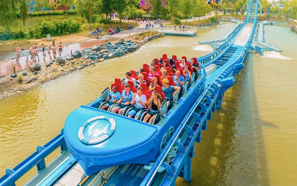 Tourists on Pulsar ride at Walibi Belgium over water track.