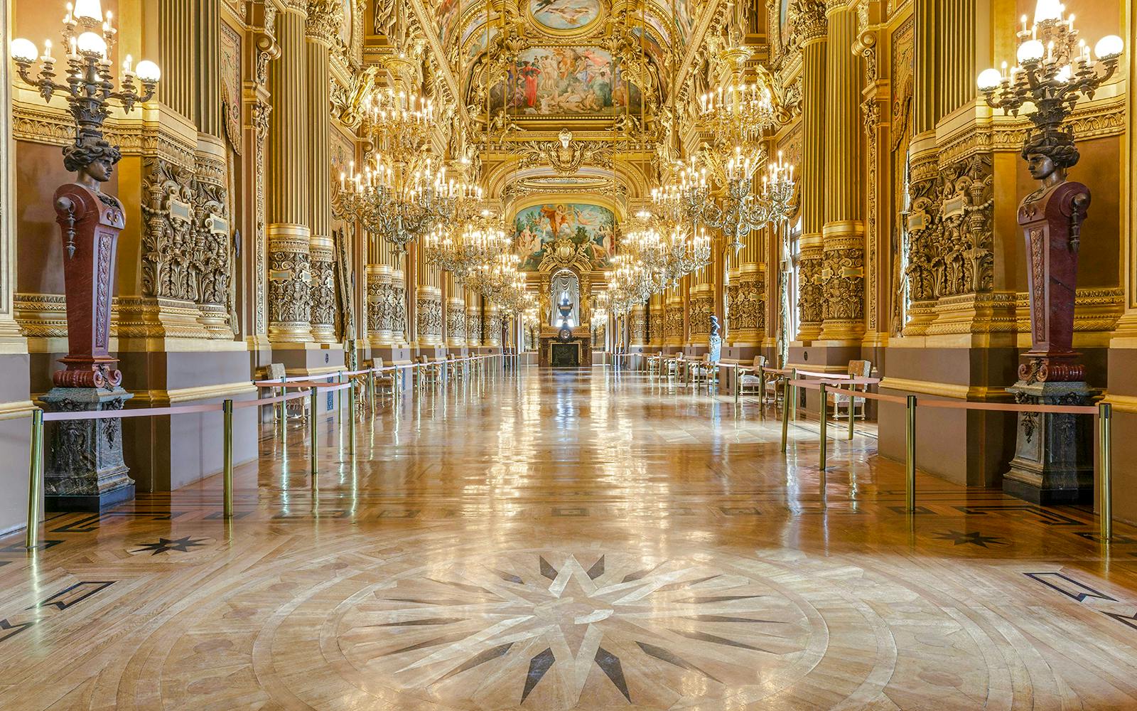 Opulent interior of Opéra Garnier with chandeliers and ornate architecture in Paris.