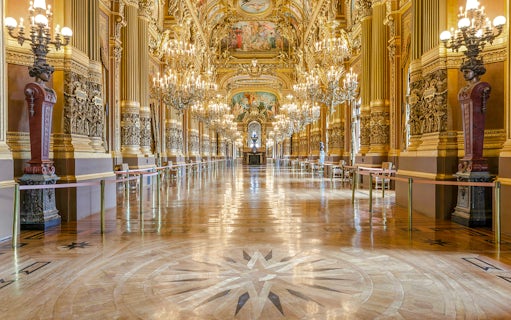 Opulent interior of Opéra Garnier with chandeliers and ornate architecture in Paris.