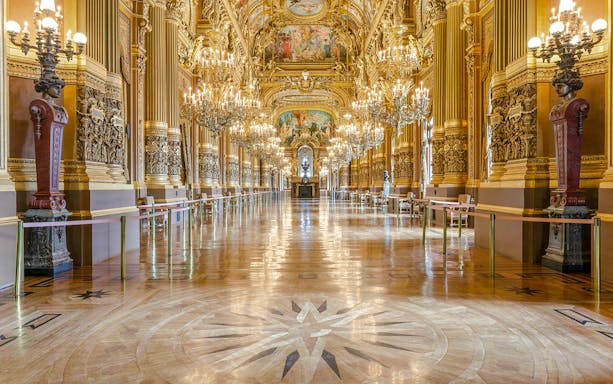 Opulent interior of Opéra Garnier with chandeliers and ornate architecture in Paris.
