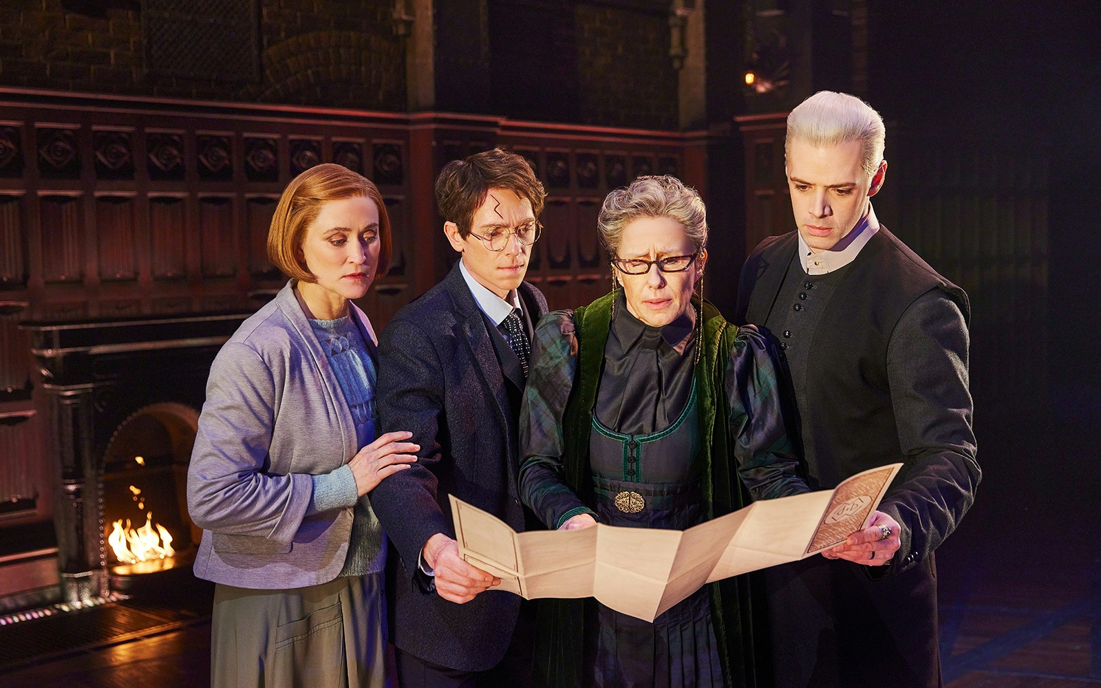 Characters examining a map in a scene from Harry Potter and the Cursed Child play.