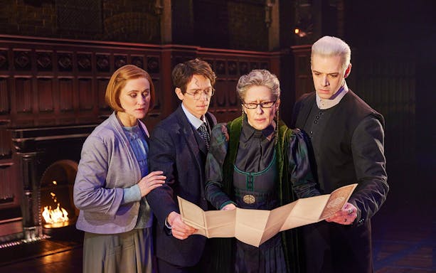 Characters examining a map in a scene from Harry Potter and the Cursed Child play.