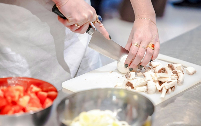 Chopping mushrooms during a small group cooking class in Florence.