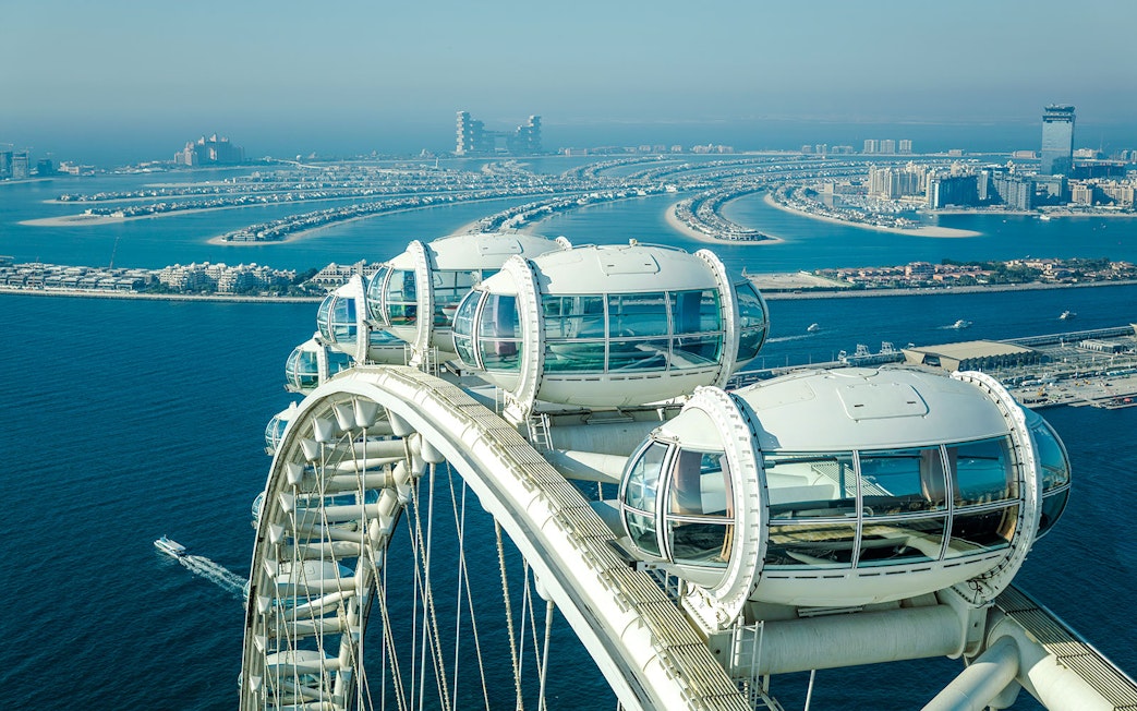 Ain Dubai observation pods overlooking the Palm Jumeirah and Dubai coastline.