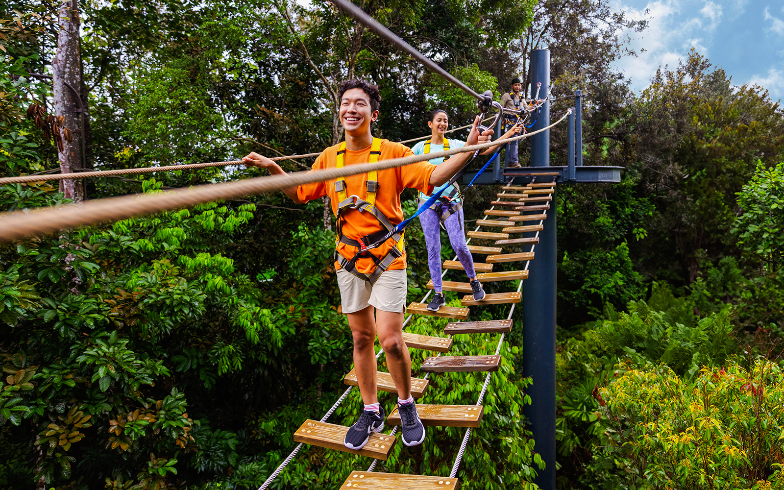 Visitors crossing a rope bridge at Wild Apex Adventure's Langur Observation Deck.