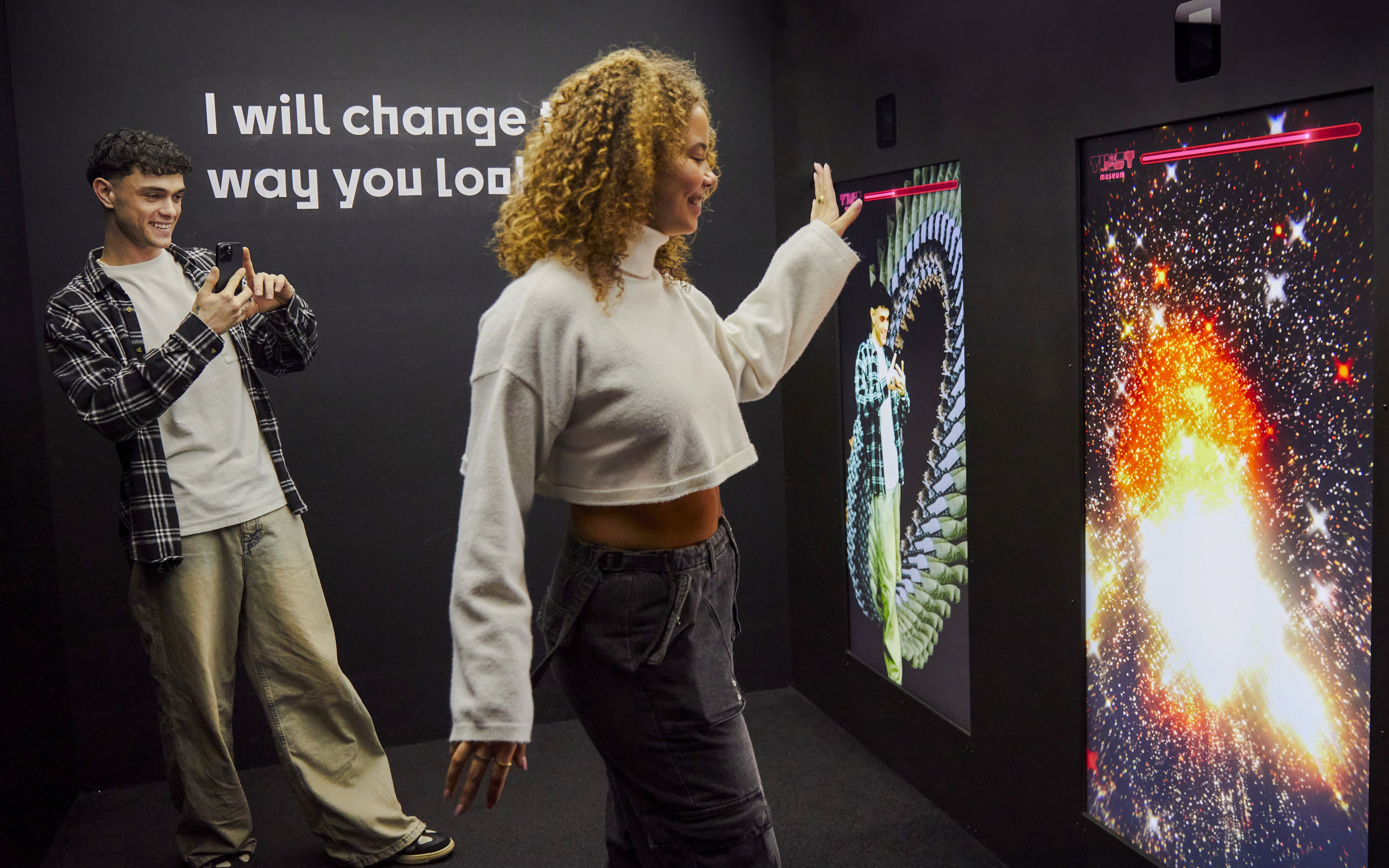 Guests interacting with digital displays at the Twist Museum in London.