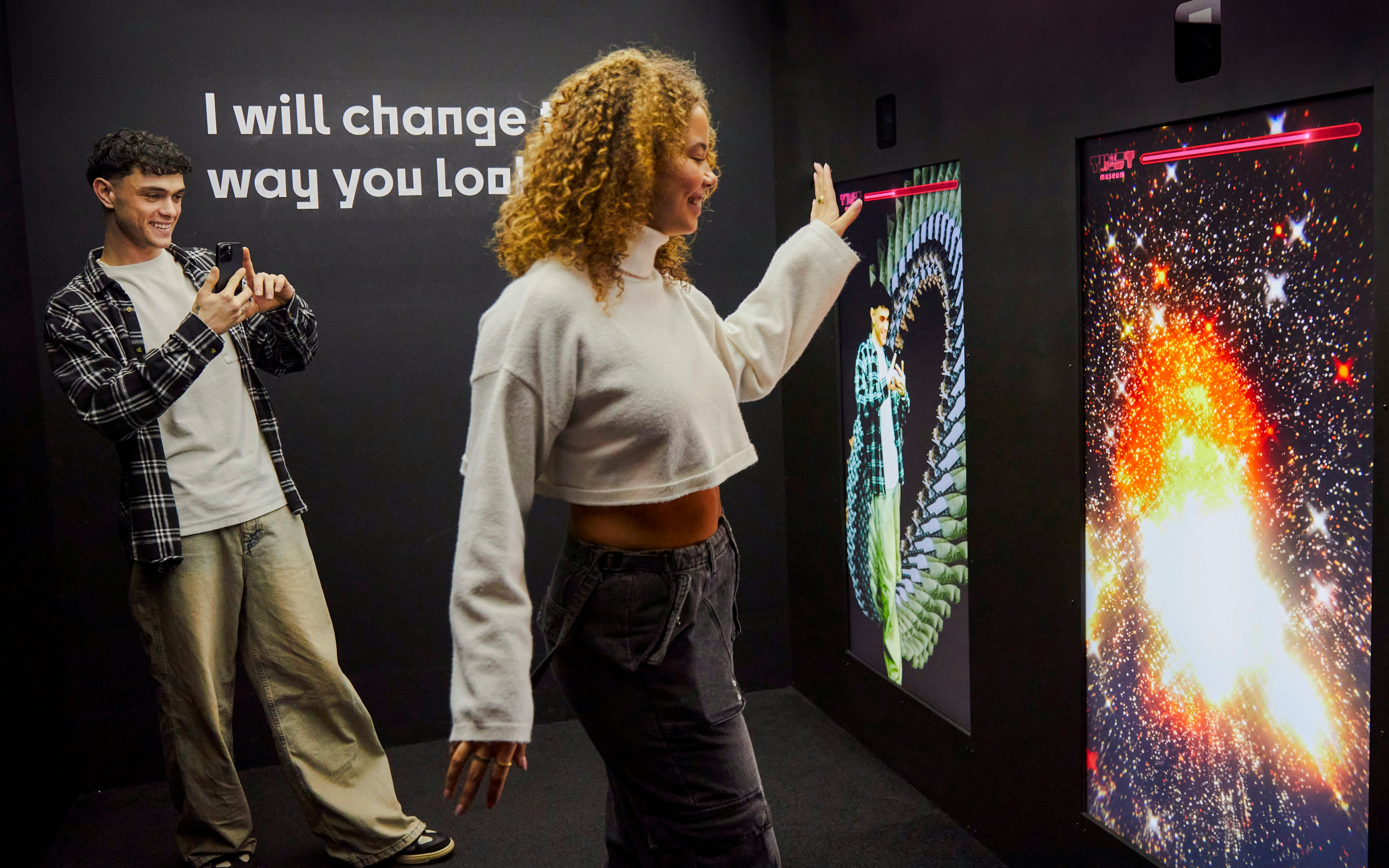 Guests interacting with digital displays at the Twist Museum in London.