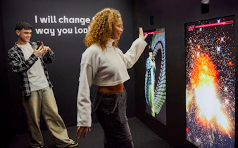Guests interacting with digital displays at the Twist Museum in London.