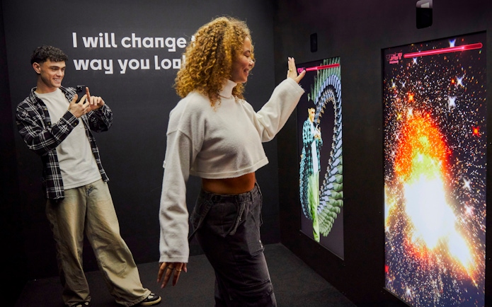Guests interacting with digital displays at the Twist Museum in London.