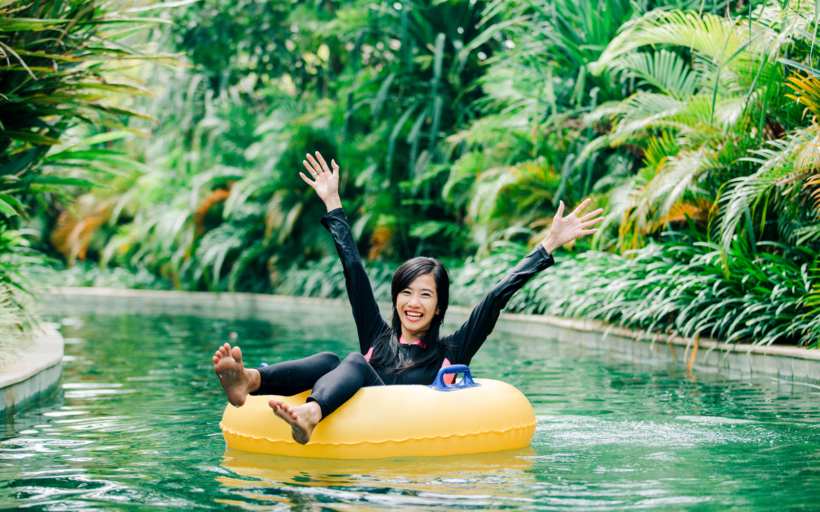 Young woman enjoying tubing on a lazy river.