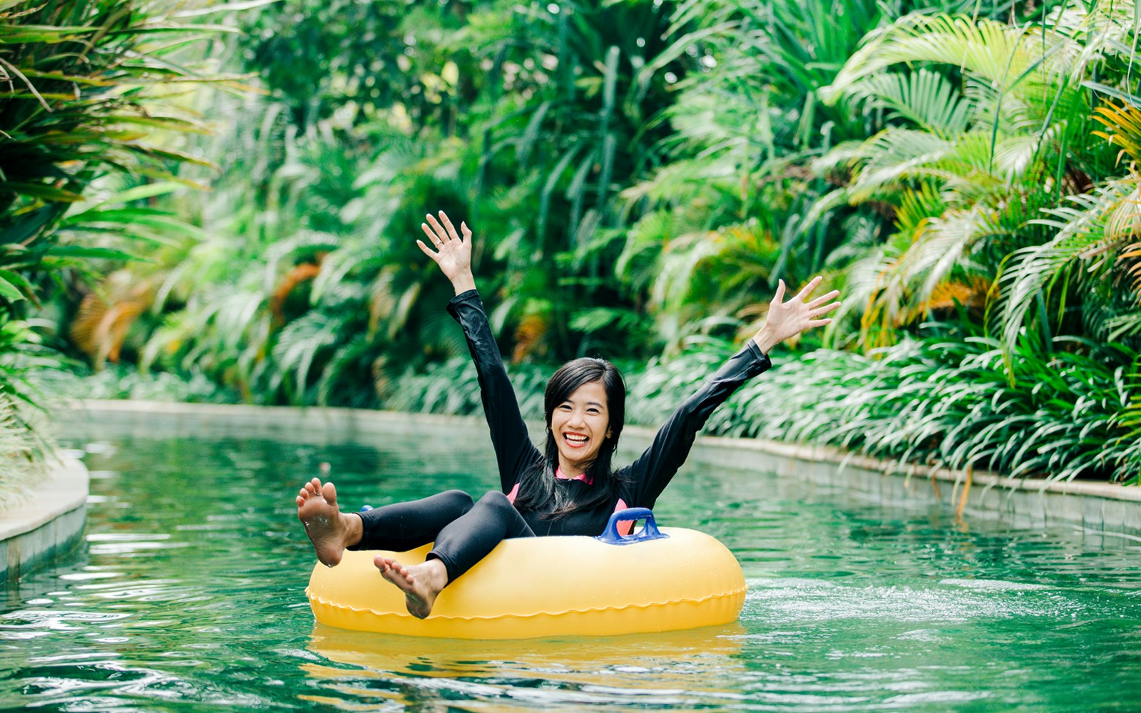 Young woman enjoying tubing in a lazy river at Andamanda Phuket