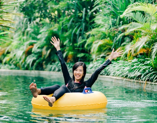 Young woman enjoying tubing on a lazy river.