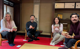 Participants enjoying a tea ceremony in a traditional Kyoto tea room.