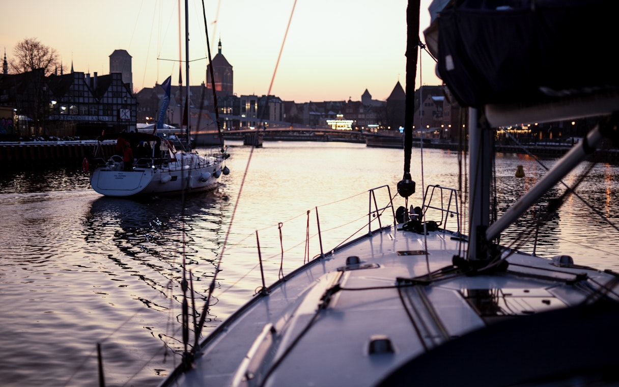 Sailboats on Gdansk River at sunset during a cruise with Prosecco.
