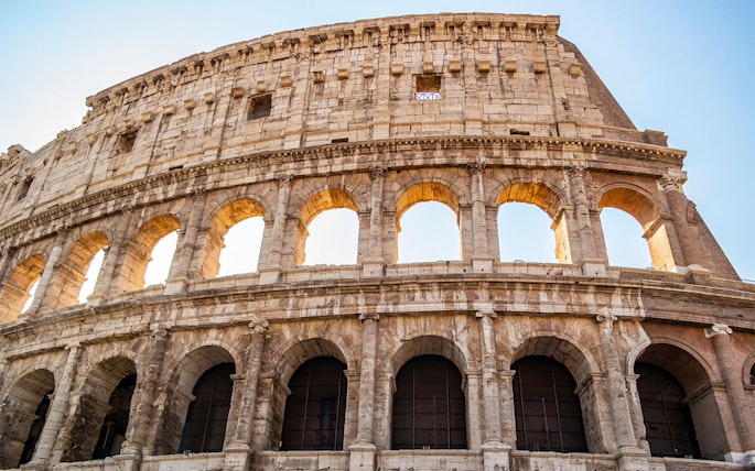 Colosseum exterior with arches, part of the Colosseum, Palatine Hill & Roman Forum tour.