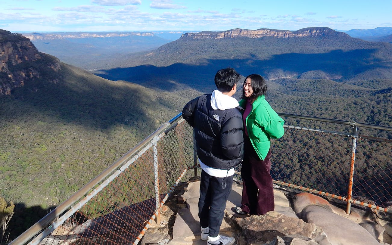 Couple enjoying the view at a Blue Mountains lookout in Australia.