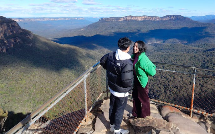 Couple enjoying the view at a Blue Mountains lookout in Australia.