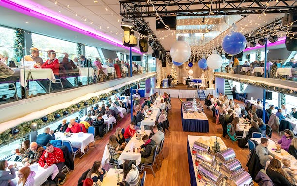Afternoon advent cruise in Cologne with guests dining and festive decorations.