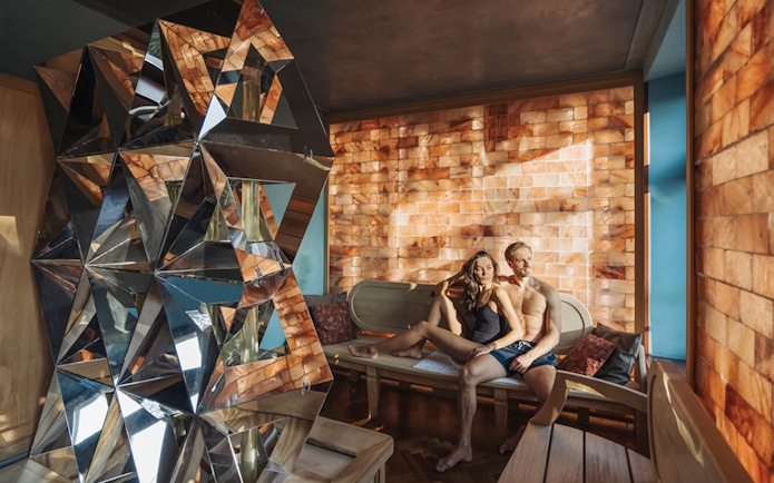 Visitors relaxing in a salt room at QC TermeTorino Spa, Italy.
