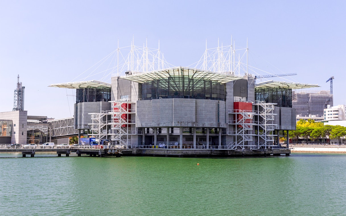 Lisbon Oceanarium exterior view with water and modern architecture.