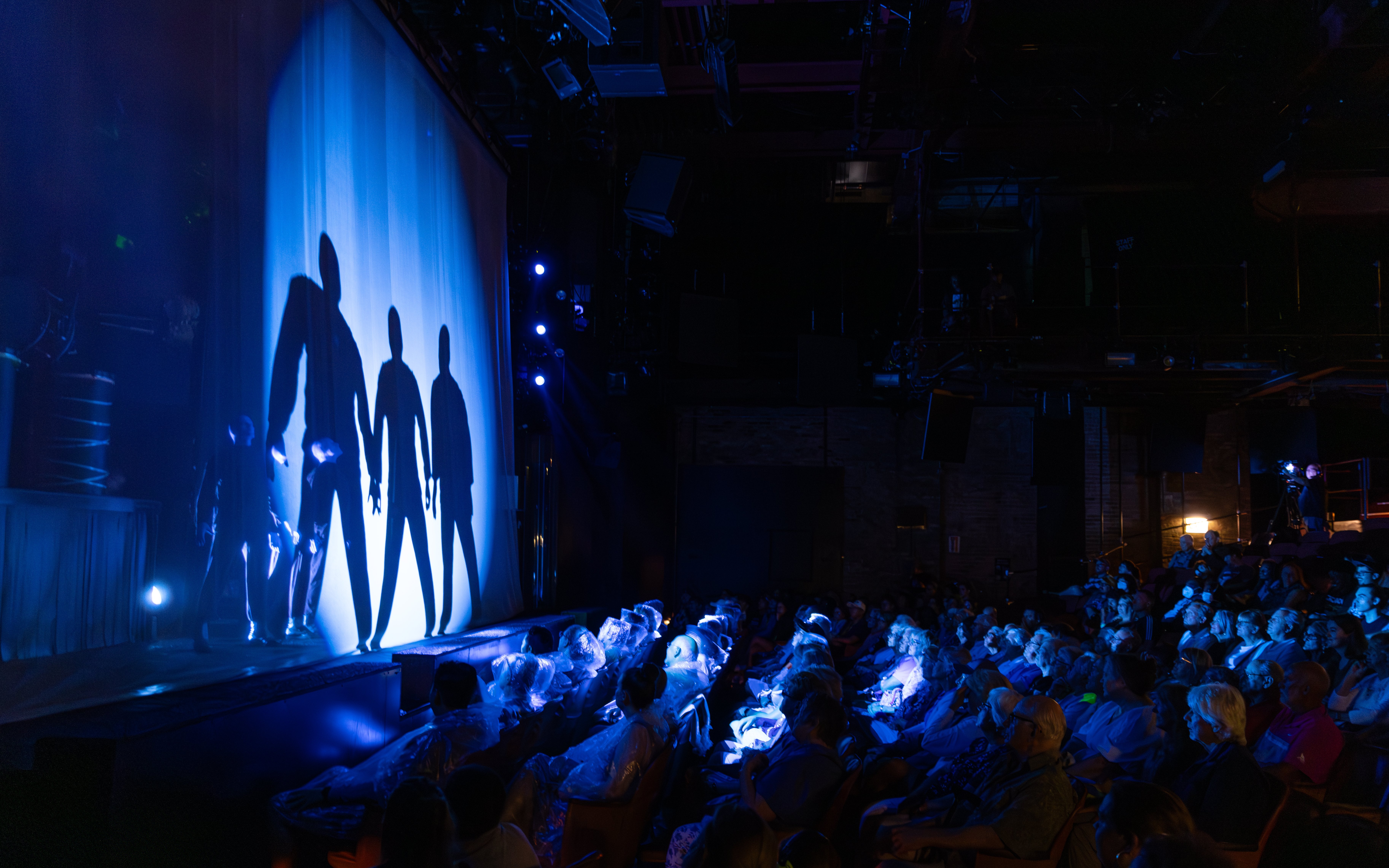 Blue Man Group performing on stage with audience in Orlando theater.